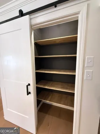 a view of empty room with window and fireplace