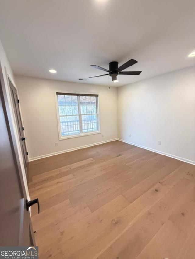 161 Hancock Road Williamson, GA 30292 - Photo 19 of 44 an empty room with windows and ceiling fan