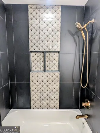 an empty room with windows and ceiling fan