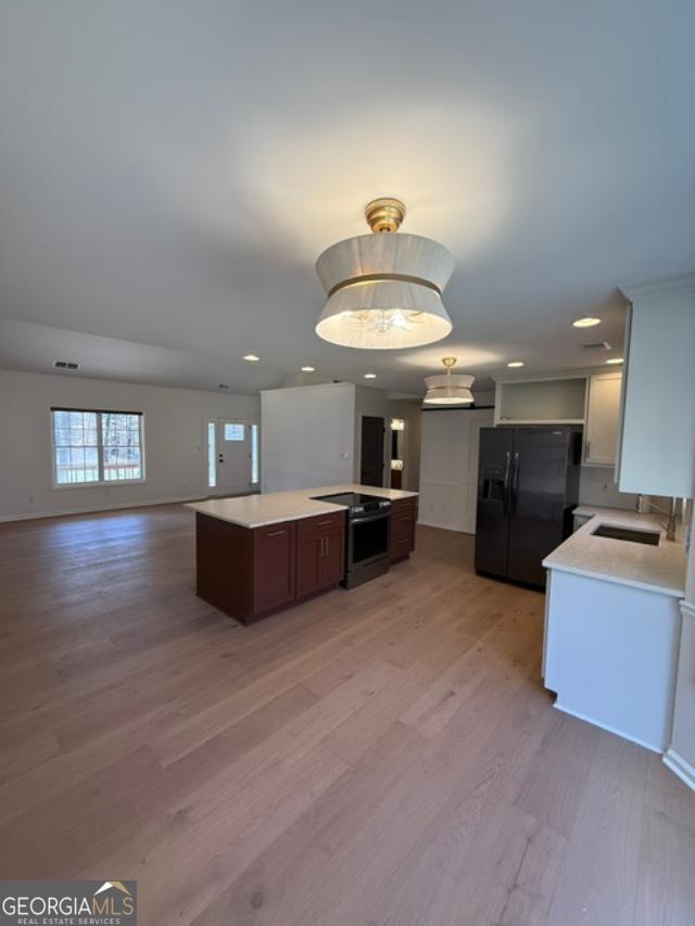161 Hancock Road Williamson, GA 30292 - Photo 6 of 44 a living room with furniture and a chandelier