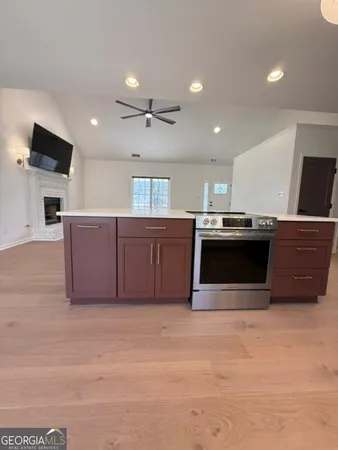 a kitchen with stainless steel appliances granite countertop a stove a sink and a microwave