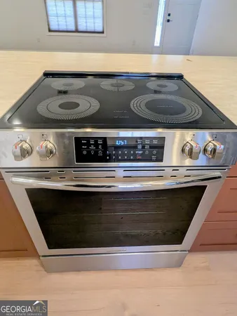 a stove top oven sitting inside of a kitchen