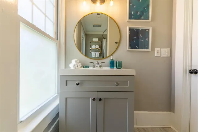 a bathroom with a sink mirror and a vanity