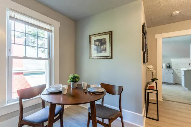 a view of a dining room with furniture window and wooden floor