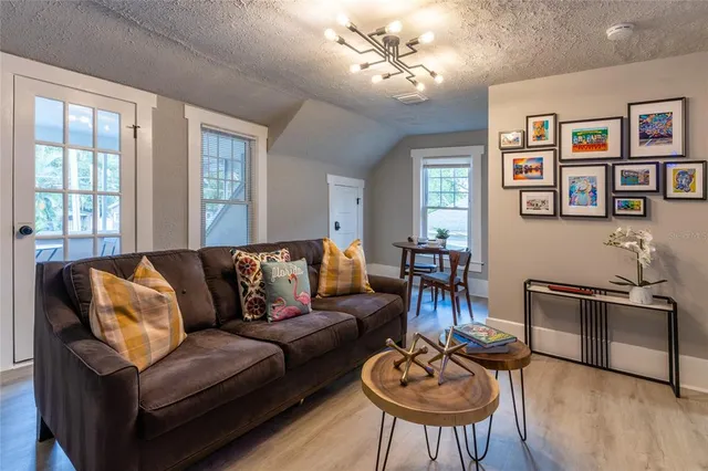 a living room with furniture a two couches and a dining table