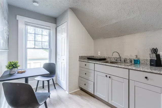 a kitchen with sink and chair