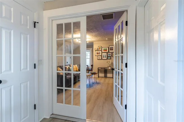 a view of a hallway with wooden floor and dining room