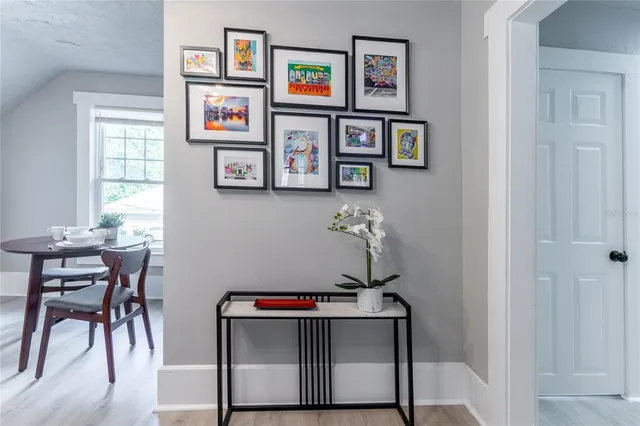 a view of a workspace with furniture and a window