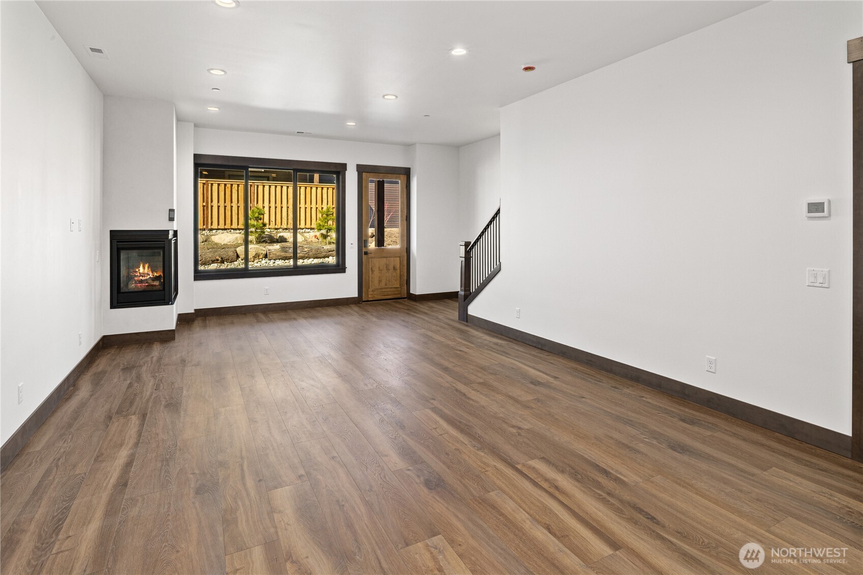 105 Riverbend Loop Cle Elum, WA 98922 - Photo 5 of 22 a view of an empty room with a window and wooden floor