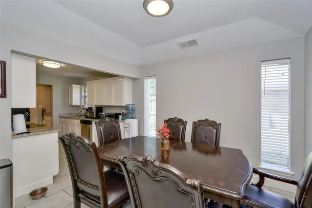 a dining room with furniture and window