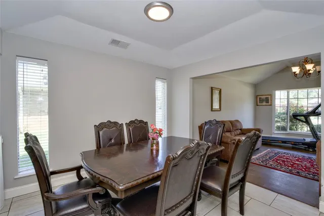 a view of a dining room with furniture and window