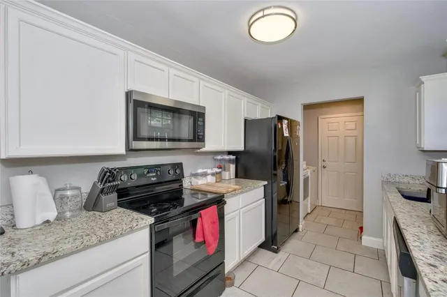 a kitchen with a sink stove and refrigerator