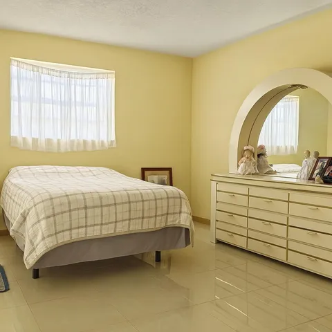 a bedroom with a bed and a dresser