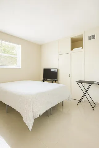 a bedroom with a bed and a table