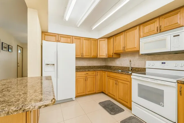 a kitchen with stainless steel appliances granite countertop a refrigerator sink and cabinets