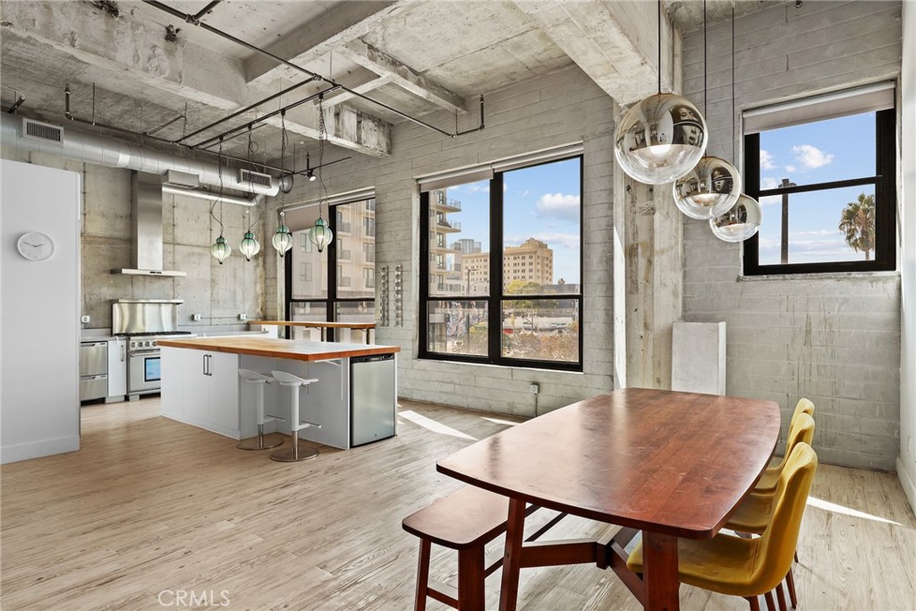 a kitchen with a table chairs and wooden floor