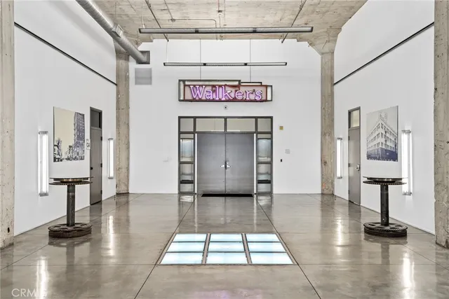 a view of a hallway with wooden floor and furniture