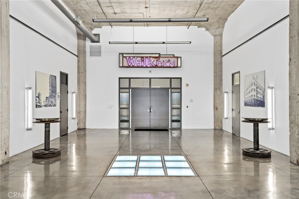 115 West 4th Street, Unit 203 Long Beach, CA 90802 - Photo 12 of 32 a view of a hallway with wooden floor and furniture