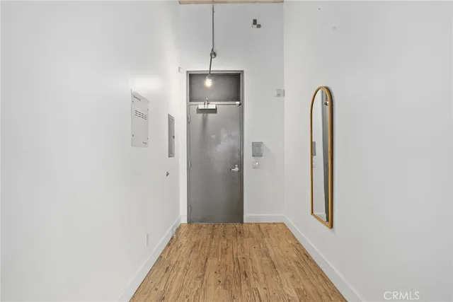 a view of a room with wooden floor and a bathroom