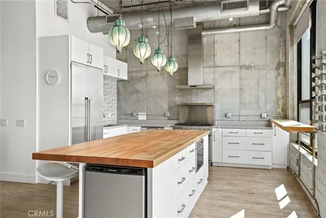 a kitchen with a wooden floor and cabinets