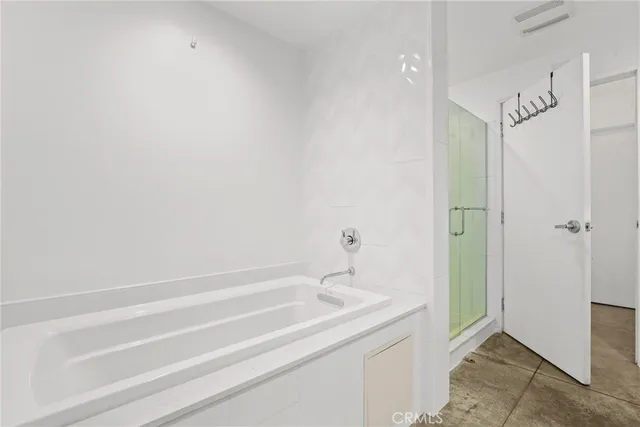 a bathroom with a granite countertop sink and shower