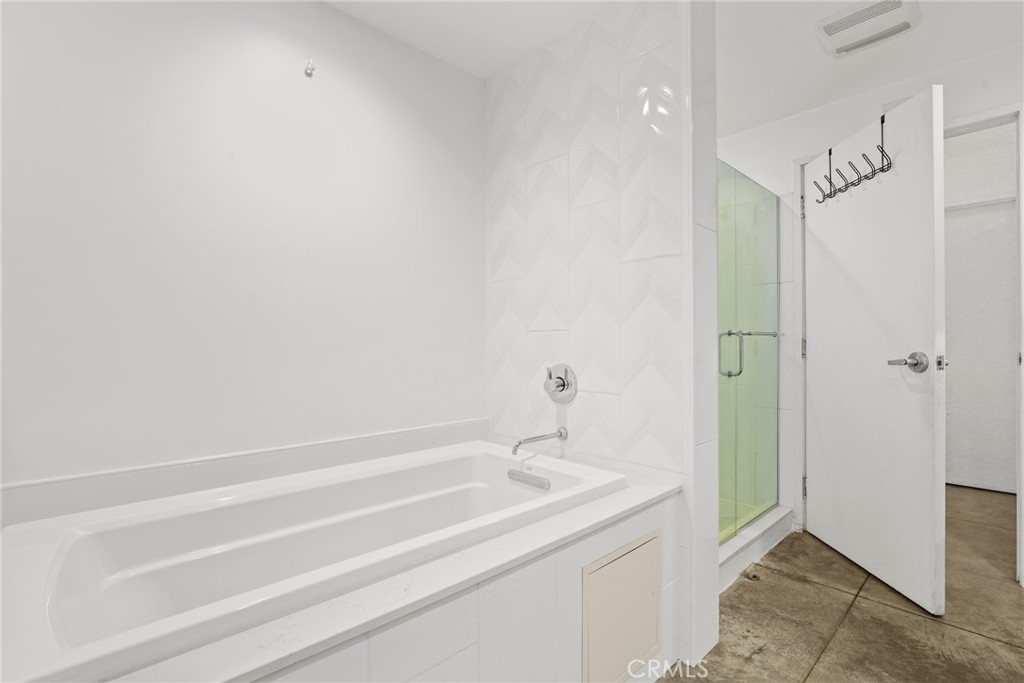 115 West 4th Street, Unit 203 Long Beach, CA 90802 - Photo 19 of 32 a bathroom with a granite countertop sink and shower