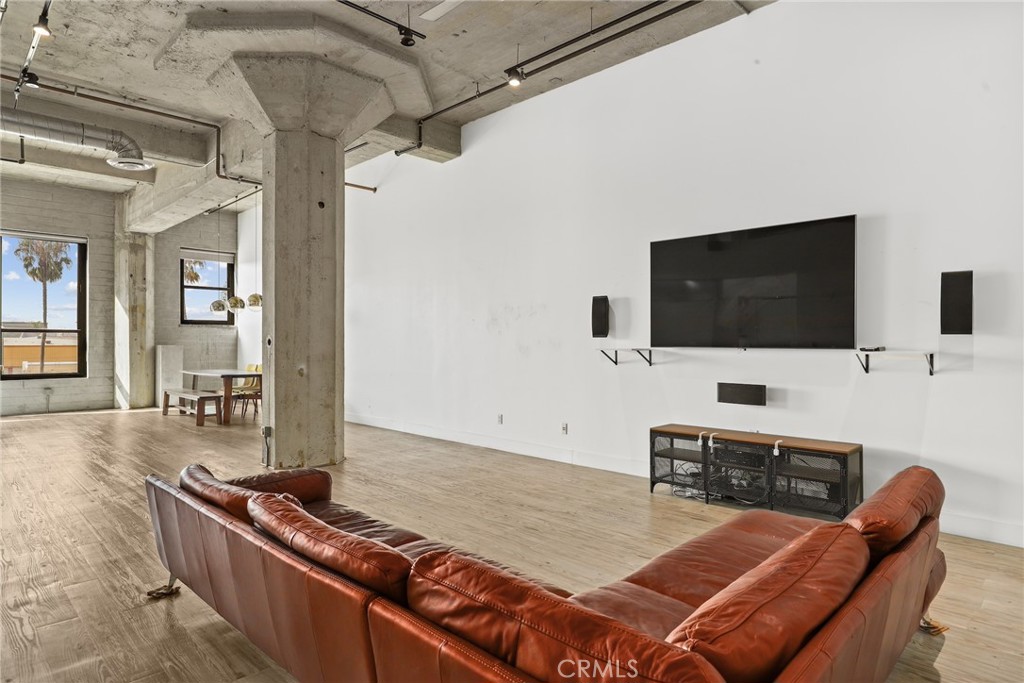 115 West 4th Street, Unit 203 Long Beach, CA 90802 - Photo 21 of 32 a living room with furniture and a flat screen tv