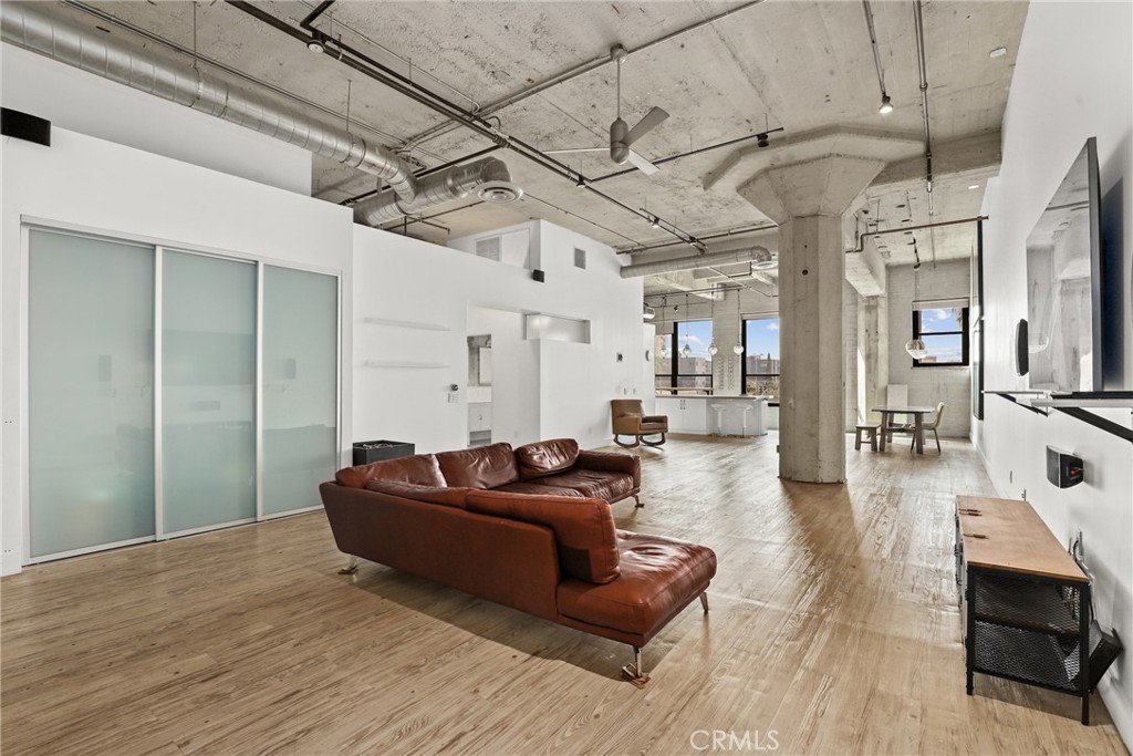 115 West 4th Street, Unit 203 Long Beach, CA 90802 - Photo 22 of 32 a living room with furniture and a flat screen tv