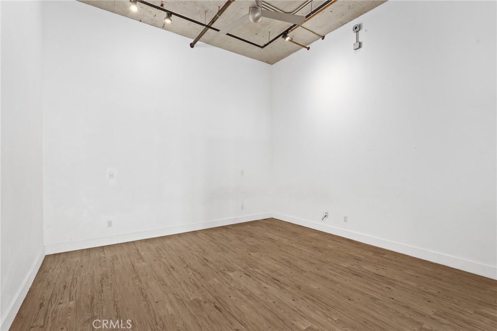 115 West 4th Street, Unit 203 Long Beach, CA 90802 - Photo 23 of 32 an empty room with wooden floor and windows