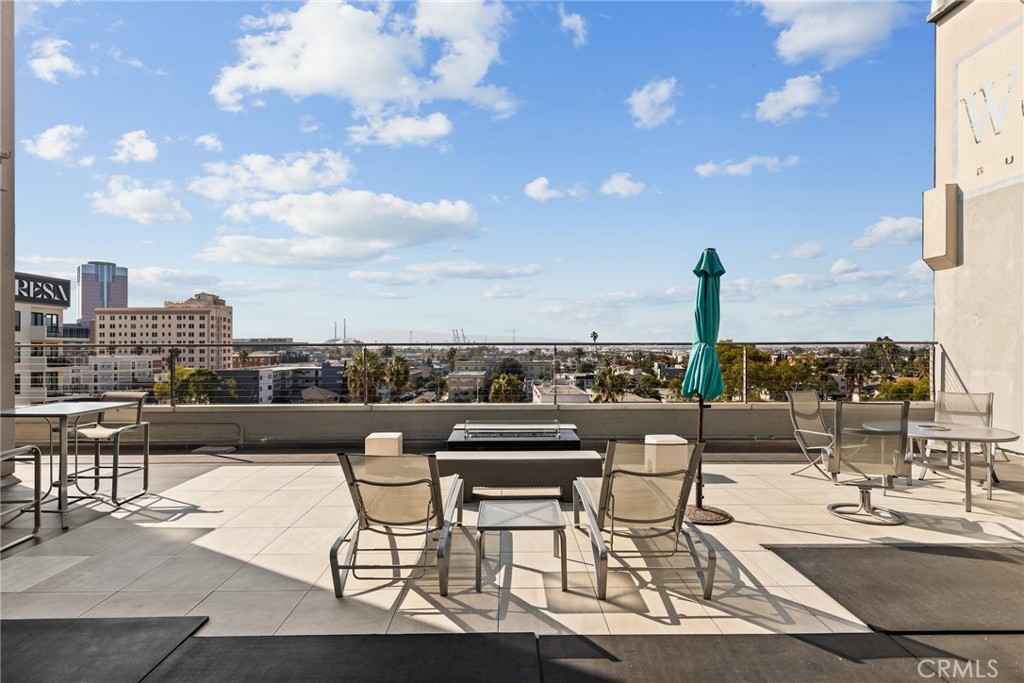 115 West 4th Street, Unit 203 Long Beach, CA 90802 - Photo 25 of 32 a view of a terrace with furniture and city view