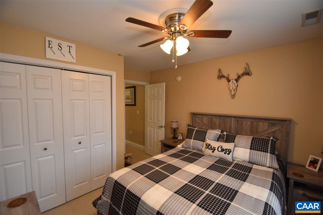 155 Pine Ridge Road Faber, VA 22938 - Photo 12 of 30 a bedroom with a bed and a chandelier
