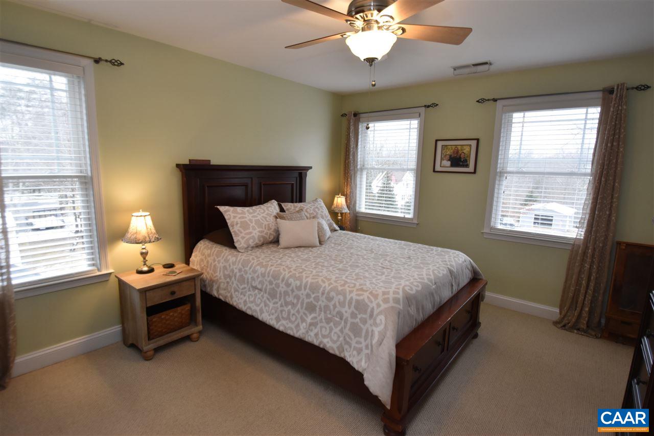 155 Pine Ridge Road Faber, VA 22938 - Photo 16 of 30 a bedroom with a bed and a chandelier