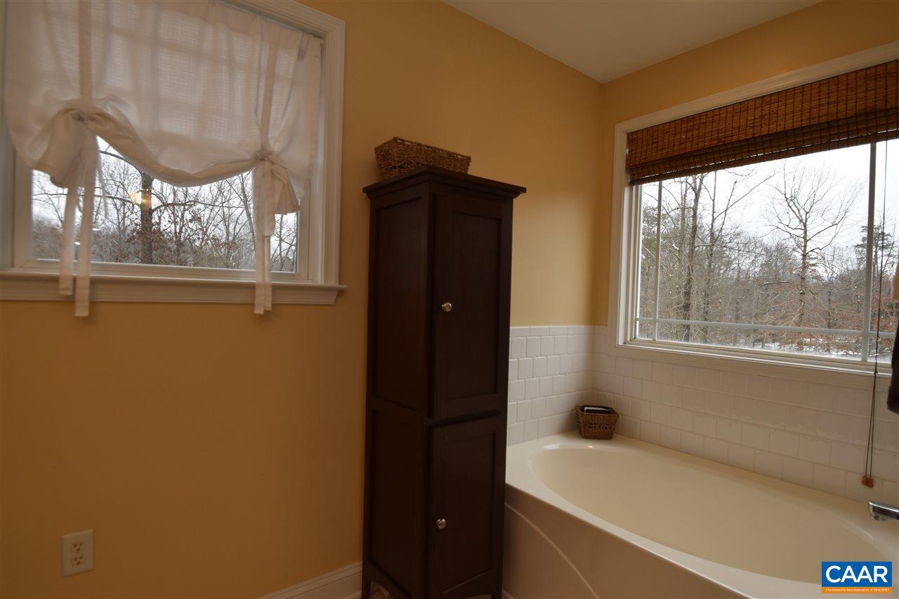 155 Pine Ridge Road Faber, VA 22938 - Photo 18 of 30 a bathroom with a bathtub and a window