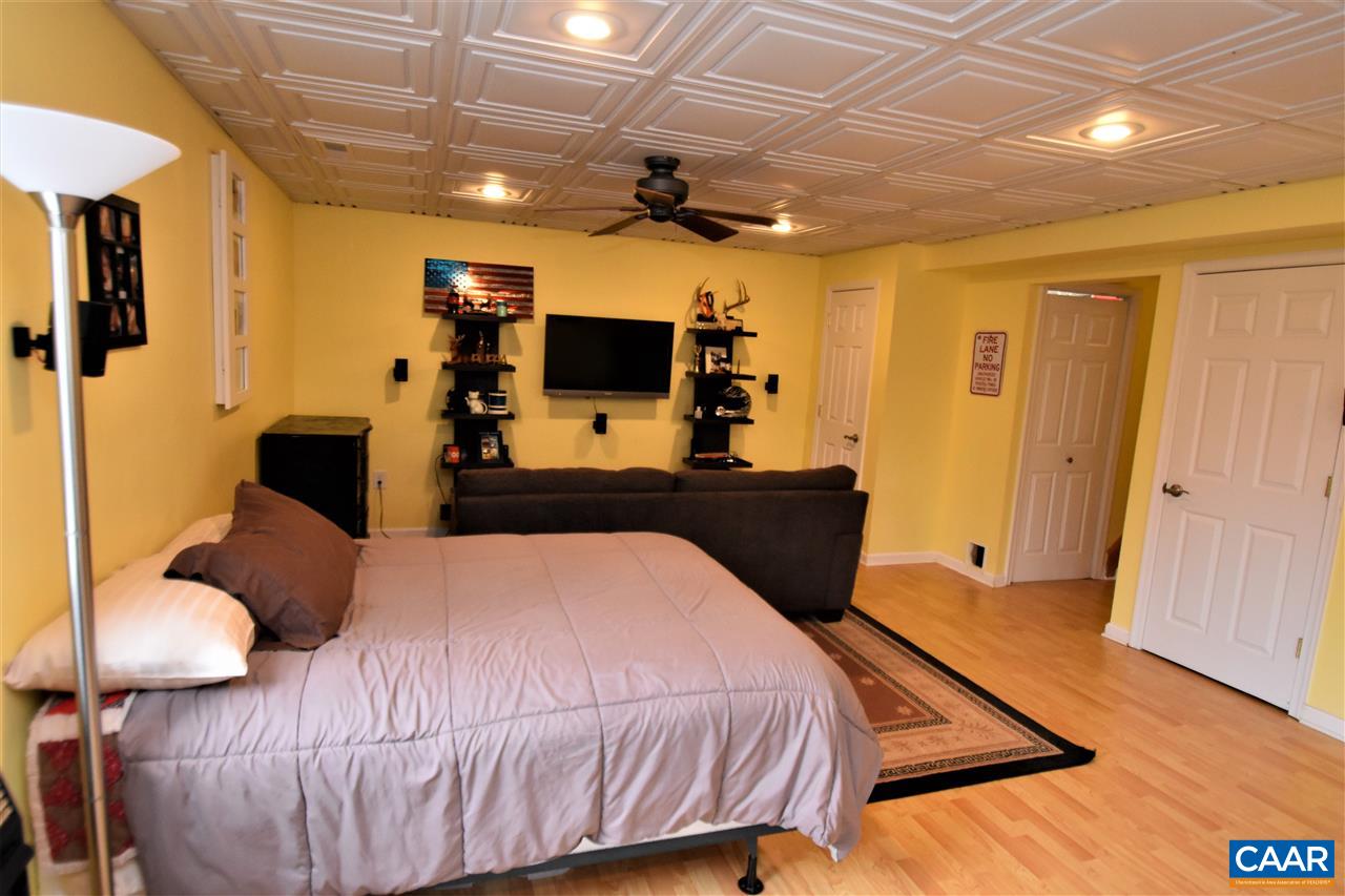 155 Pine Ridge Road Faber, VA 22938 - Photo 20 of 30 a bedroom with a bed and wooden floor
