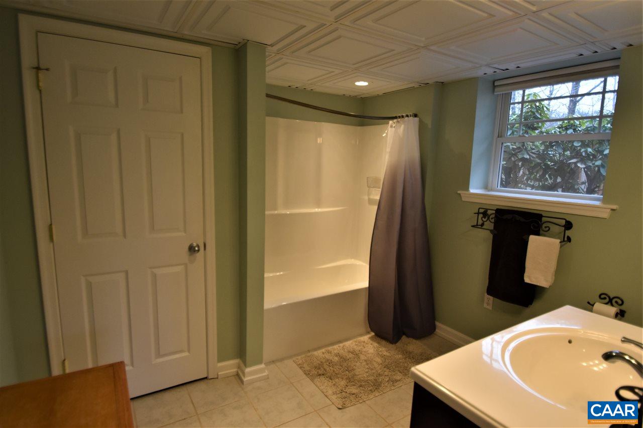 155 Pine Ridge Road Faber, VA 22938 - Photo 23 of 30 a bathroom with a sink and a mirror