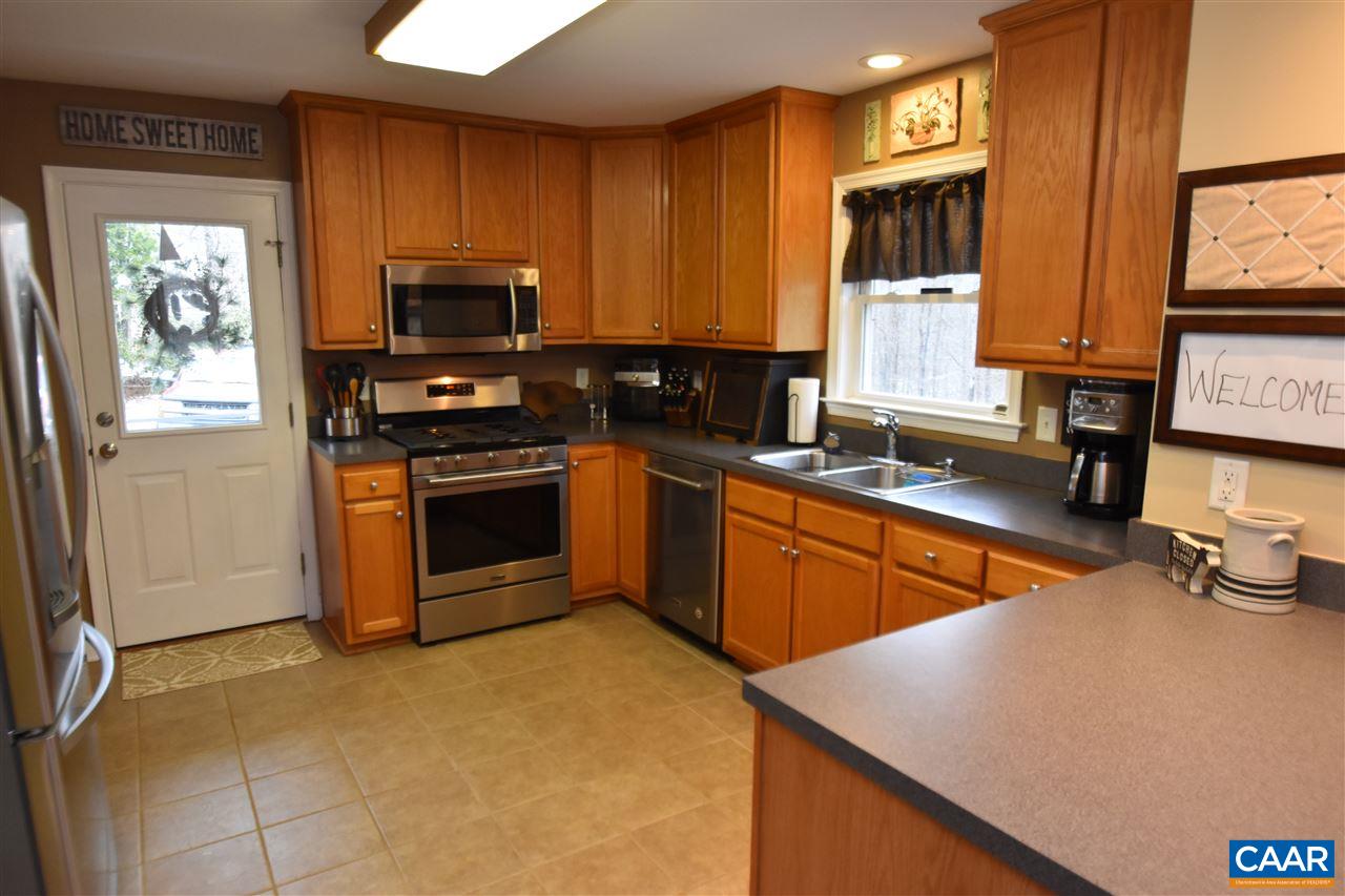 155 Pine Ridge Road Faber, VA 22938 - Photo 7 of 30 a kitchen with stainless steel appliances a stove a sink a microwave a refrigerator a window and cabinets