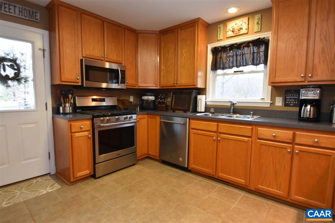 155 Pine Ridge Road Faber, VA 22938 - Photo 9 of 30 a kitchen with stainless steel appliances granite countertop a stove a sink dishwasher and a microwave oven with cabinets