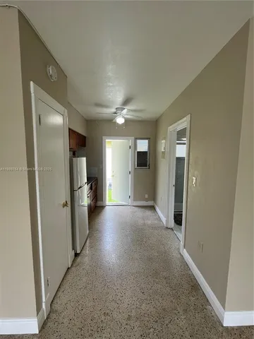 a view of a hallway with wooden floor