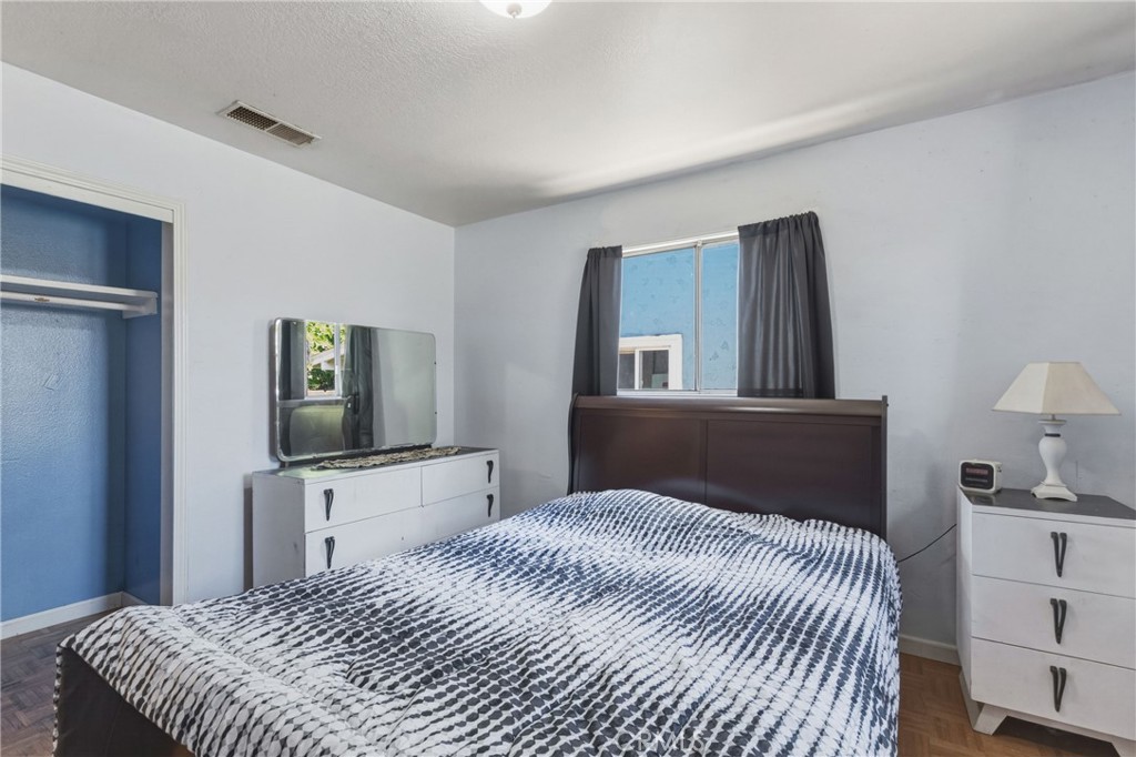 6812 Helton Street Winton, CA 95388 - Photo 11 of 24 a bedroom with a bed and dresser with mirror