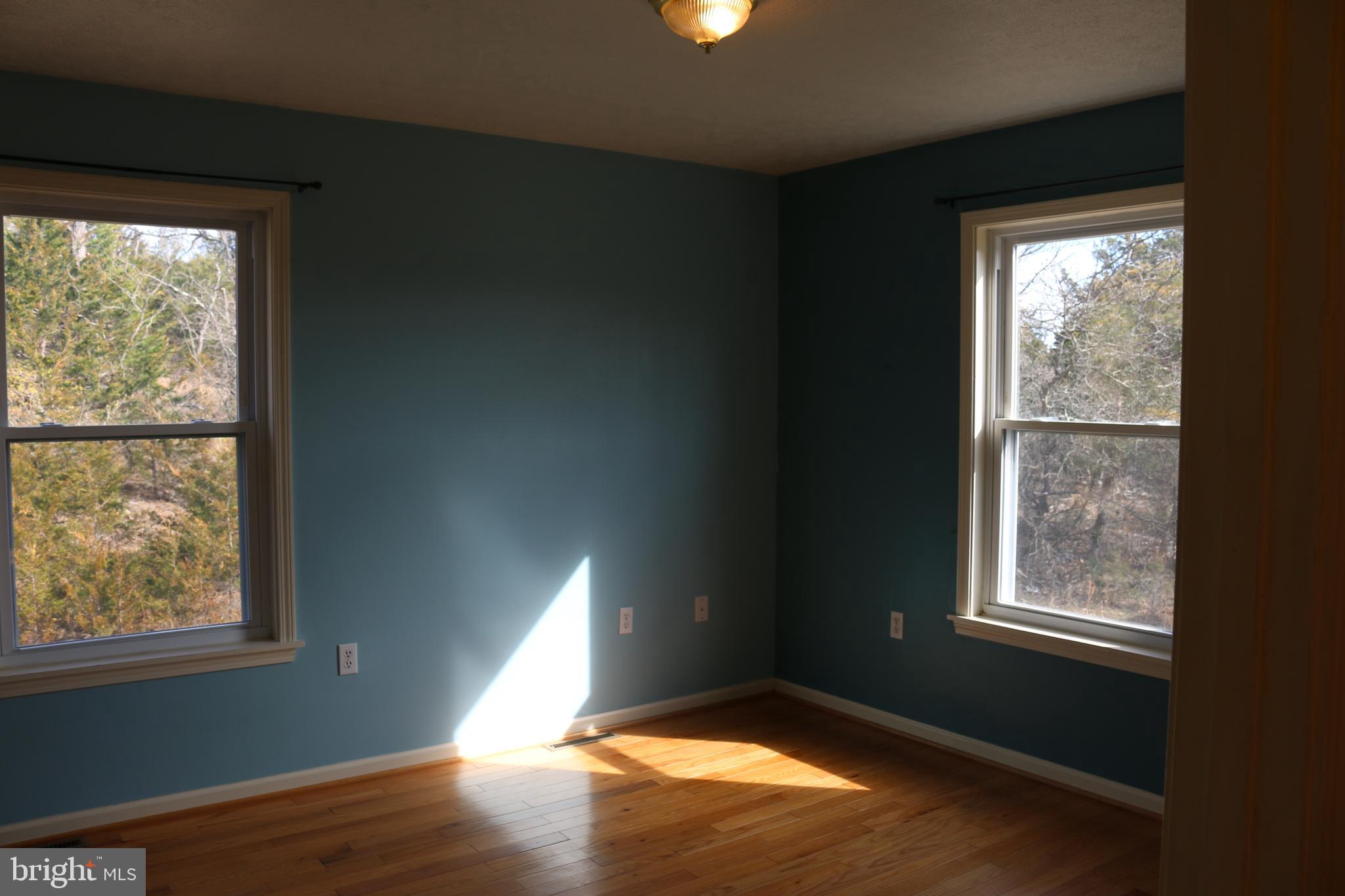 156 Squirrel Den Road Maysville, WV 26833 - Photo 25 of 41 a view of an empty room with wooden floor and a window