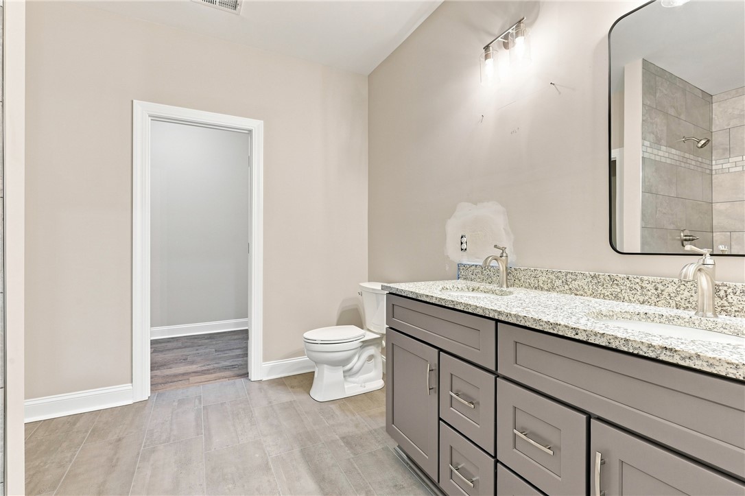 216 West Halfway Branch Road Walhalla, SC 29691 - Photo 14 of 41 Polished granite counters and matching tile floors highlight this refined double vanity bathroom.