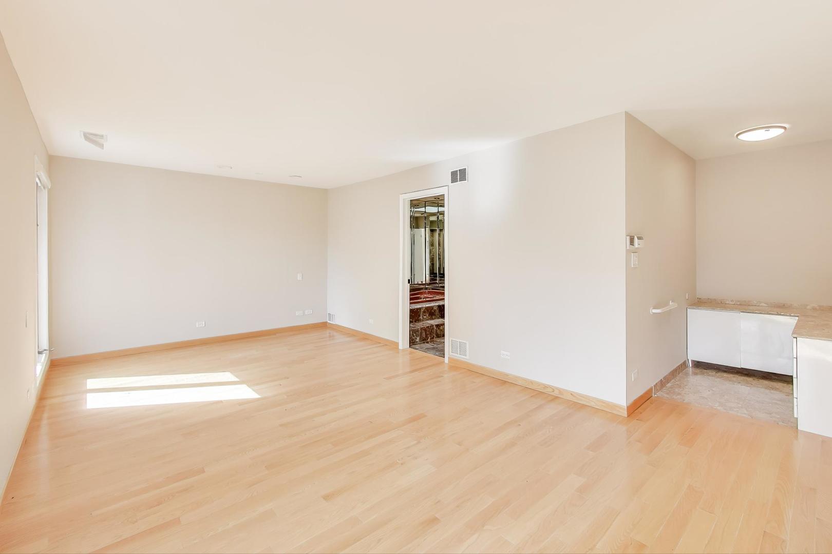 300 Boardwalk Place Park Ridge, IL 60068 - Photo 18 of 52 a view of an empty room with wooden floor and a window