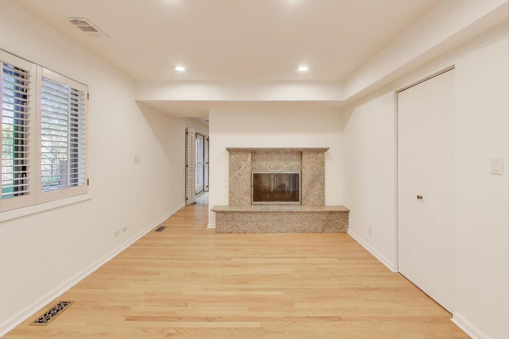 300 Boardwalk Place Park Ridge, IL 60068 - Photo 40 of 52 a view of an empty room with wooden floor and a window