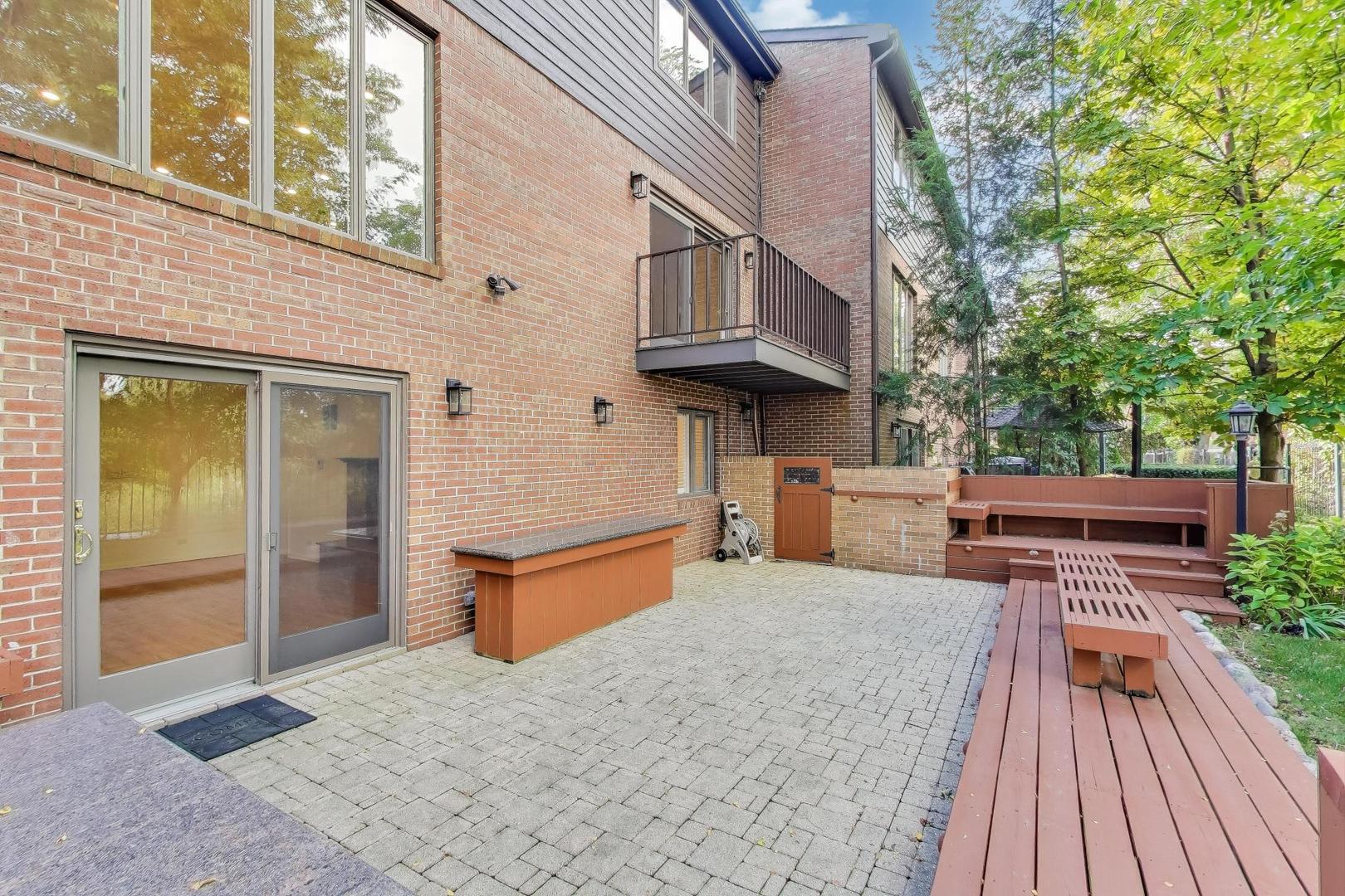 300 Boardwalk Place Park Ridge, IL 60068 - Photo 48 of 52 a backyard of a house with wooden floor and outdoor seating