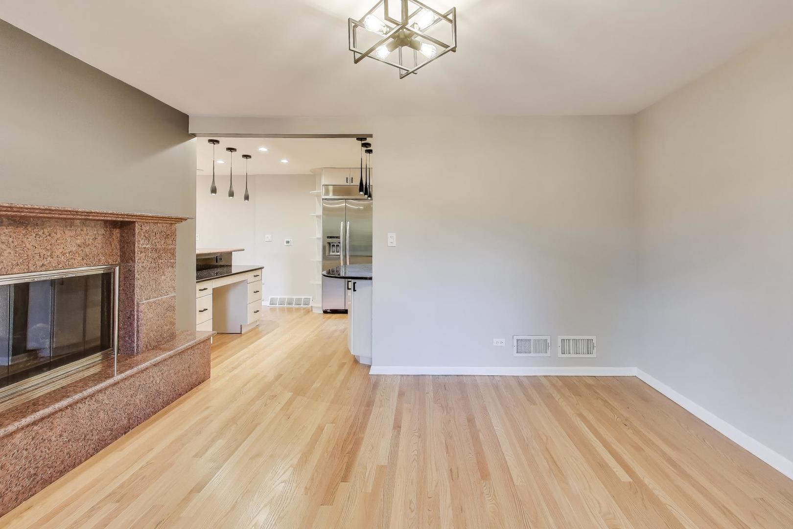 300 Boardwalk Place Park Ridge, IL 60068 - Photo 8 of 52 a view of empty room with wooden floor and fireplace