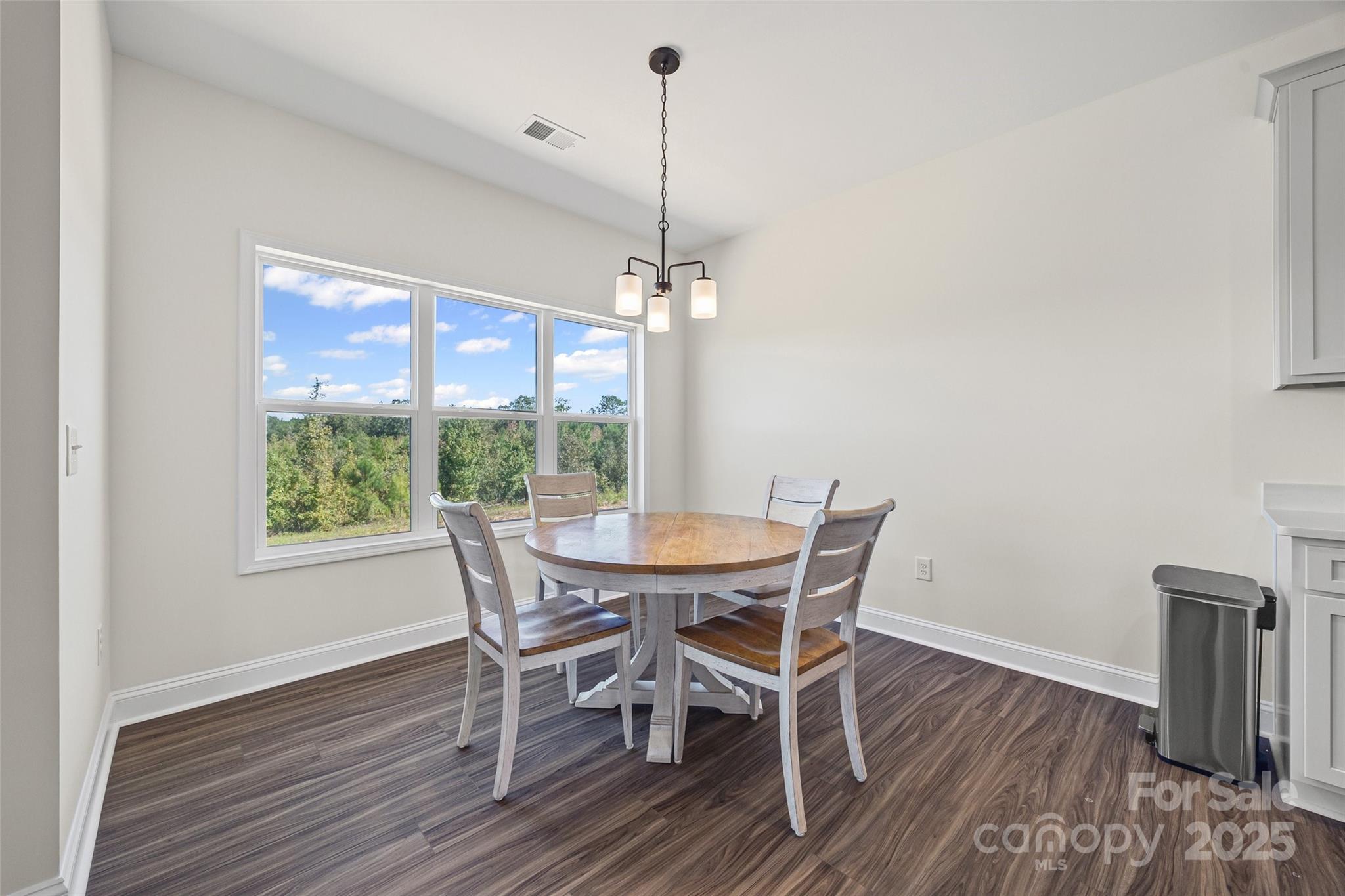 4822 Bull Run Road Blackstock, SC 29014 - Photo 12 of 34 a view of a dining room with furniture window and wooden floor