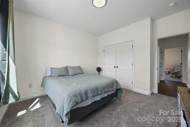 a spacious bedroom with a bed and cabinets