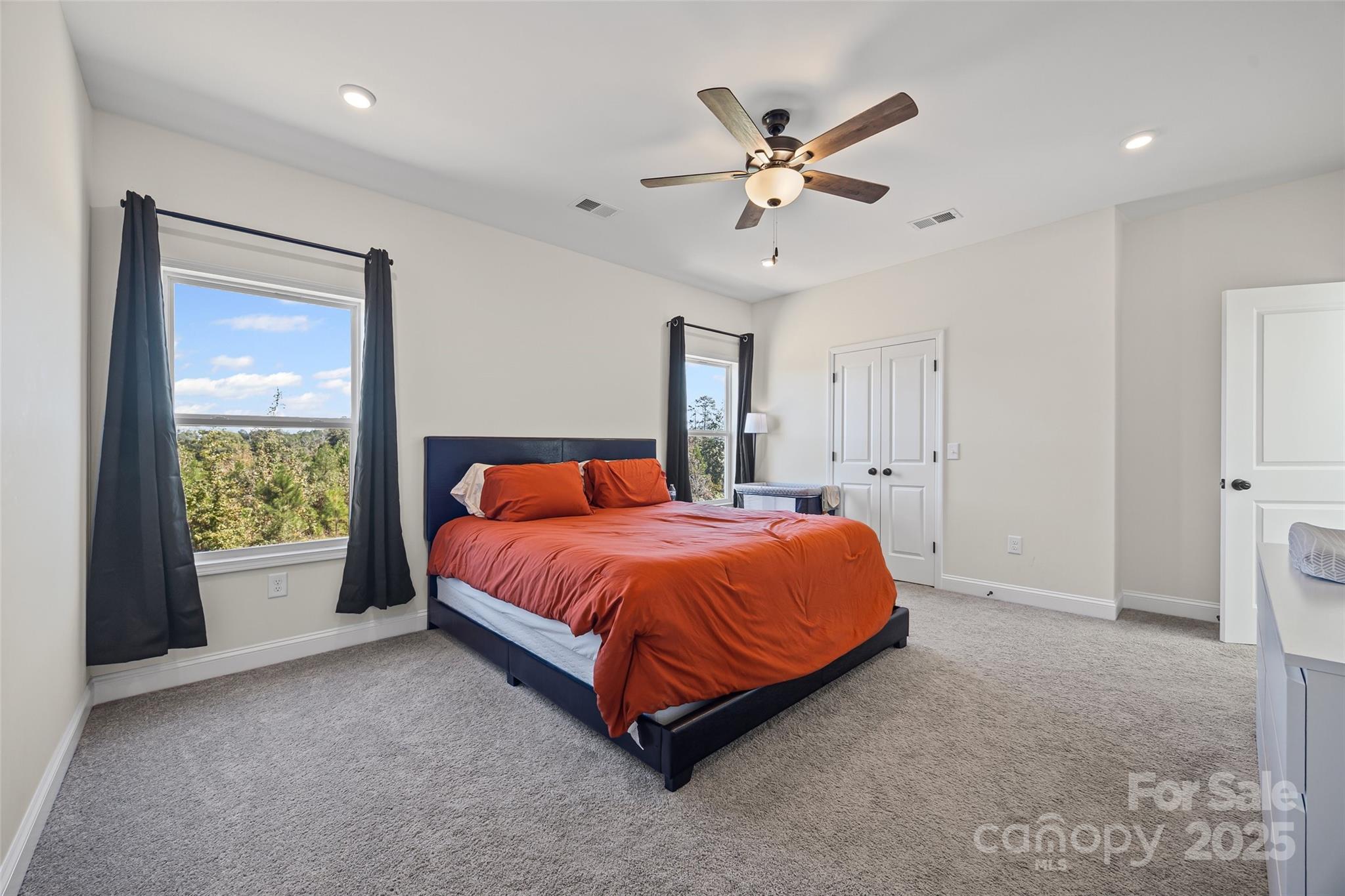 4822 Bull Run Road Blackstock, SC 29014 - Photo 19 of 34 a spacious bedroom with a bed and a chandelier