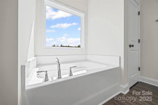 a bathroom with a bathtub and a window