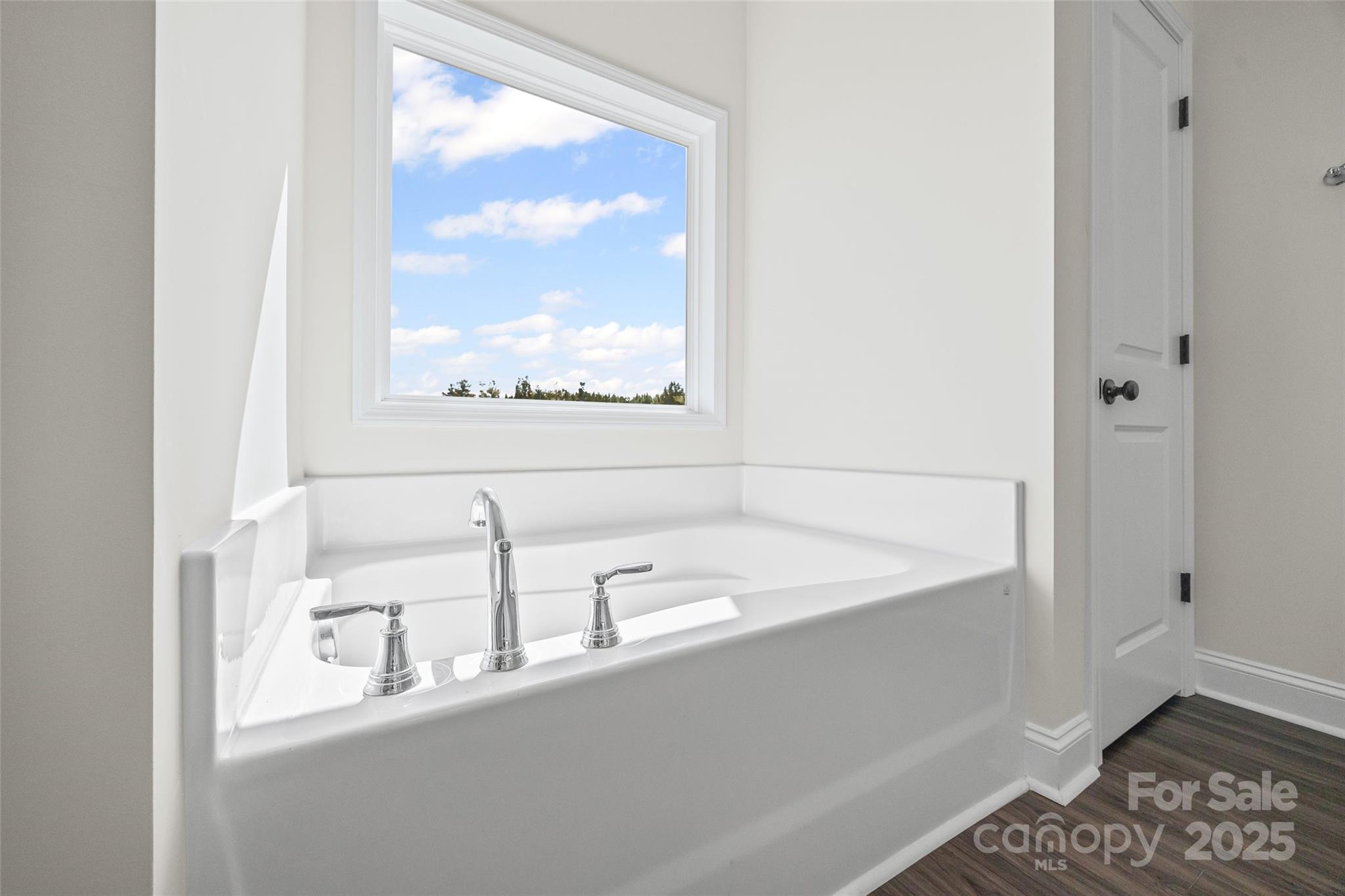 4822 Bull Run Road Blackstock, SC 29014 - Photo 23 of 34 a bathroom with a bathtub and a window
